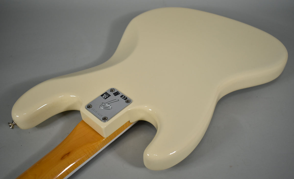 The back of an Olympic White Jazz Bass, angled to show the neck joint and chrome neck plate with a faint scratch.