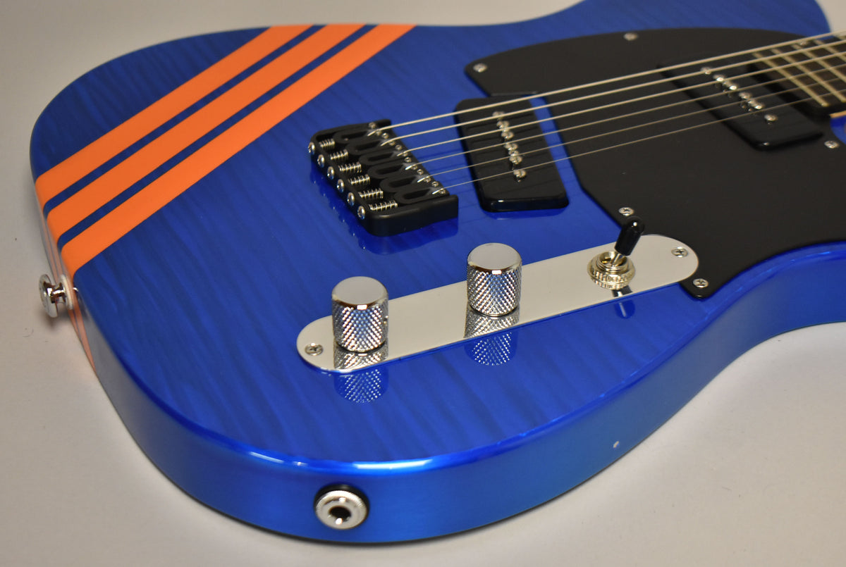 Close-up of the guitar's lower body, showing the blue flame finish with orange stripes, black pickguard, and chrome controls.