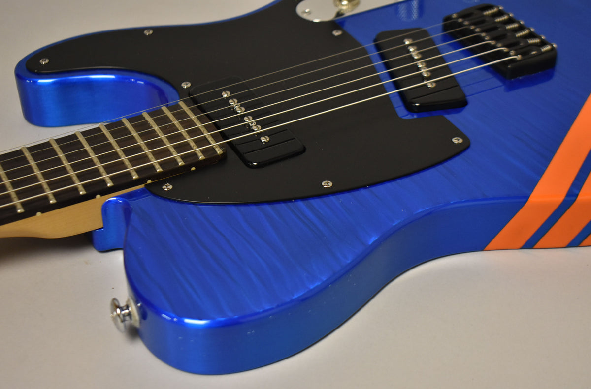 Close-up of the blue flame top body with black pickguard, two P-90 pickups, black hardtail bridge, and orange competition stripes.