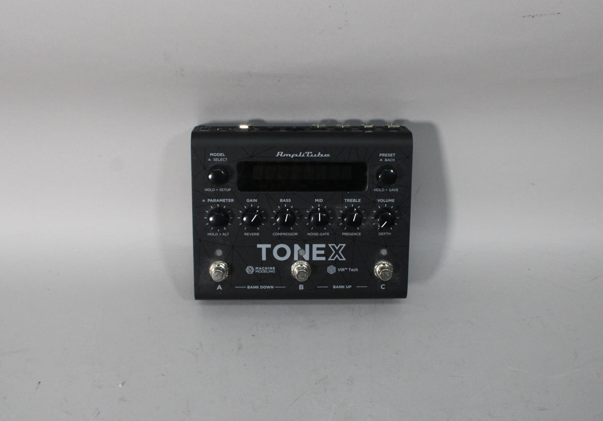 Black multi-effects pedal with a small screen, 10 control knobs, and 3 footswitches, viewed from above.