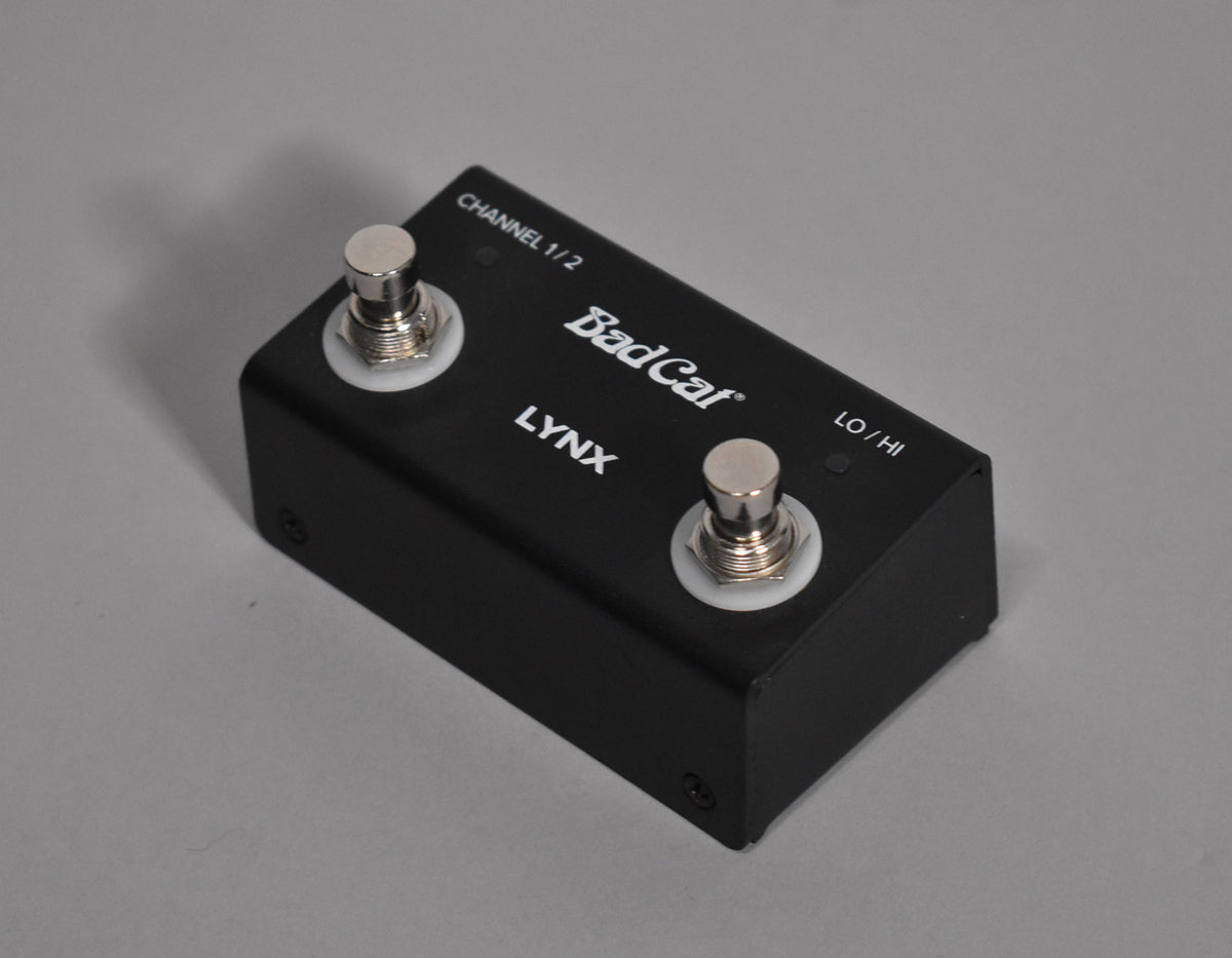 Black metal footswitch with two silver stomp buttons, labeled "CHANNEL 1/2" and "LO/HI", viewed from a slight angle above.