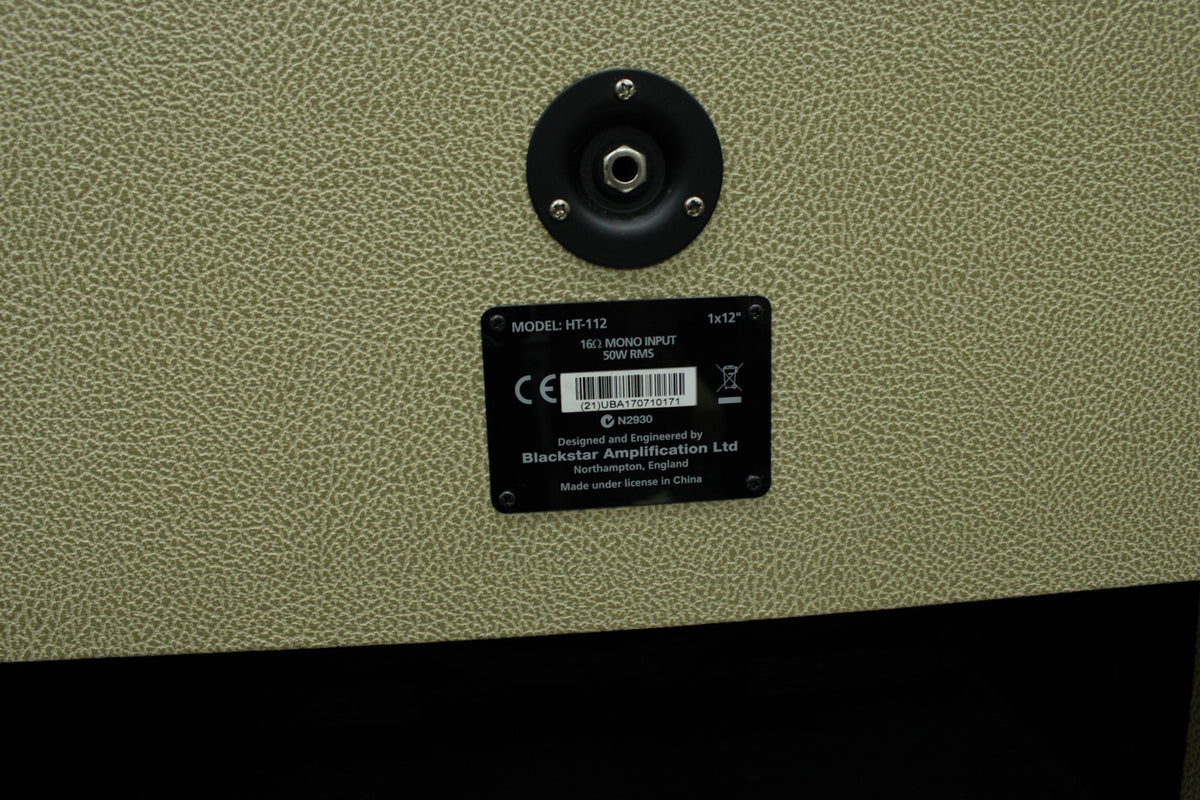 Close-up of the blonde textured tolex rear panel, showing the input jack and black metal information plate with white text.