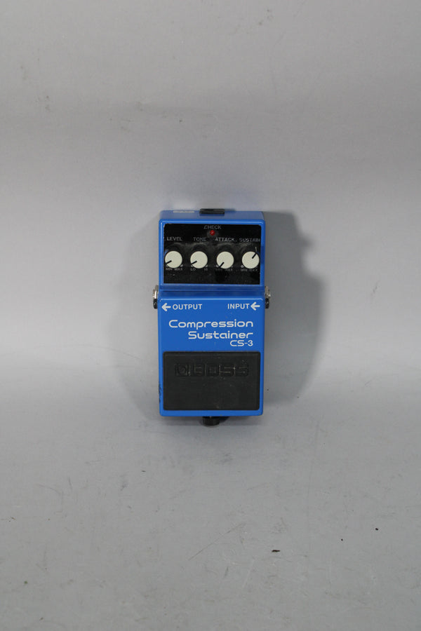 A blue effect pedal with a black footpad, four white control knobs, and a red indicator light, viewed from above.