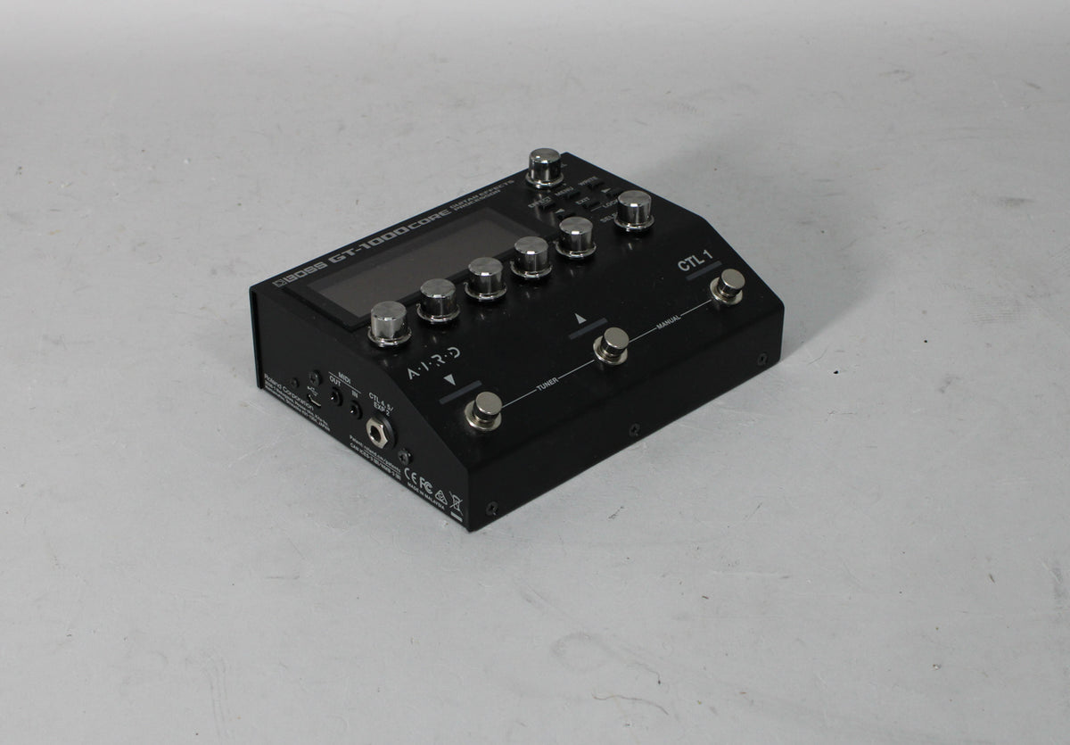 Black multi-effect processor, angled from the left, showing its display, six silver knobs, and four footswitches.
