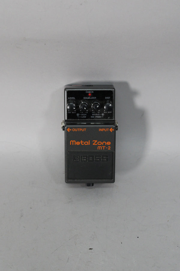 A dark gray metal effect pedal, viewed from above, with four black control knobs and a red "CHECK" indicator light.