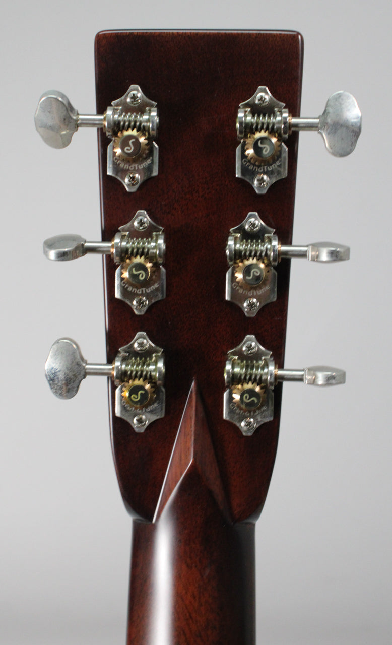 The back of a guitar headstock with six silver GrandTune tuners, three on each side, and a dark brown finish.