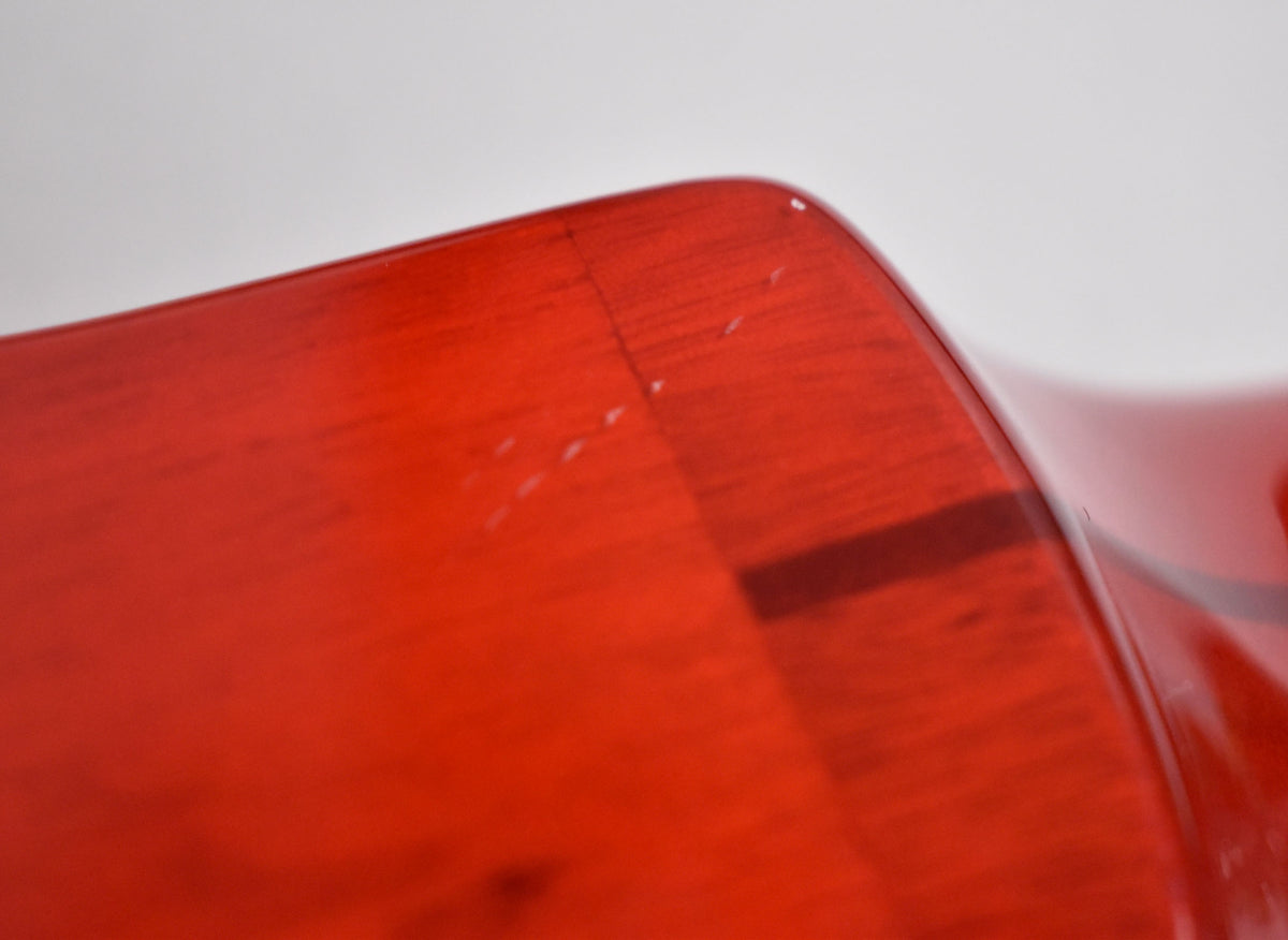Close-up of the guitar's upper bout, showing a deep cinnamon finish with visible wood grain, a finish crack, and several small dings.