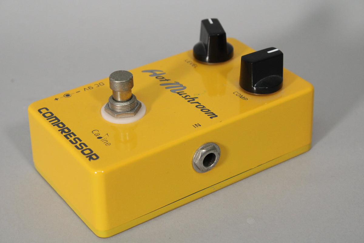 Yellow guitar pedal, angled from the right, showing the footswitch, two black control knobs, and an input jack on the right side.