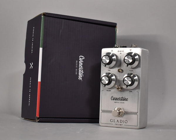 Silver pedal with four black-capped knobs, a toggle switch, and a footswitch, next to its black box with an Italian flag stripe.