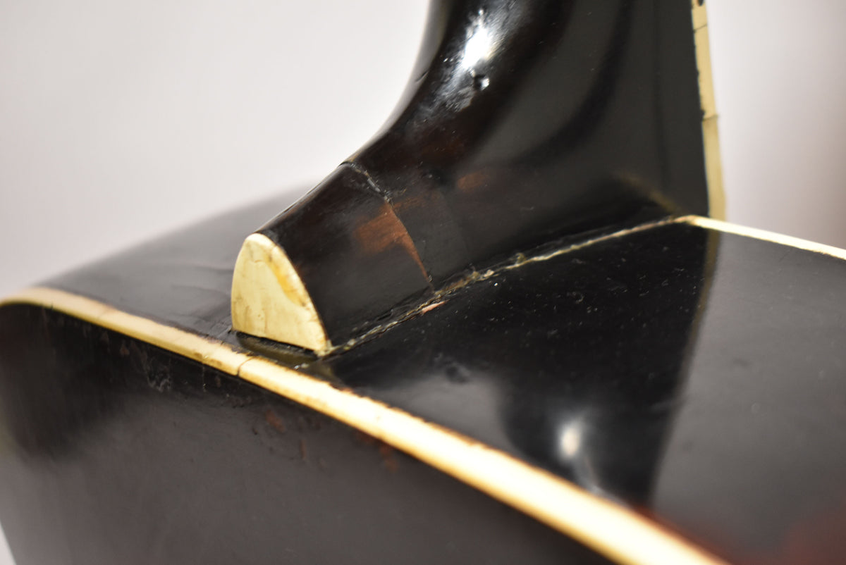 Close-up of the guitar's dark sunburst body and neck joint, showing finish wear, checking, and a small chip on the heel.