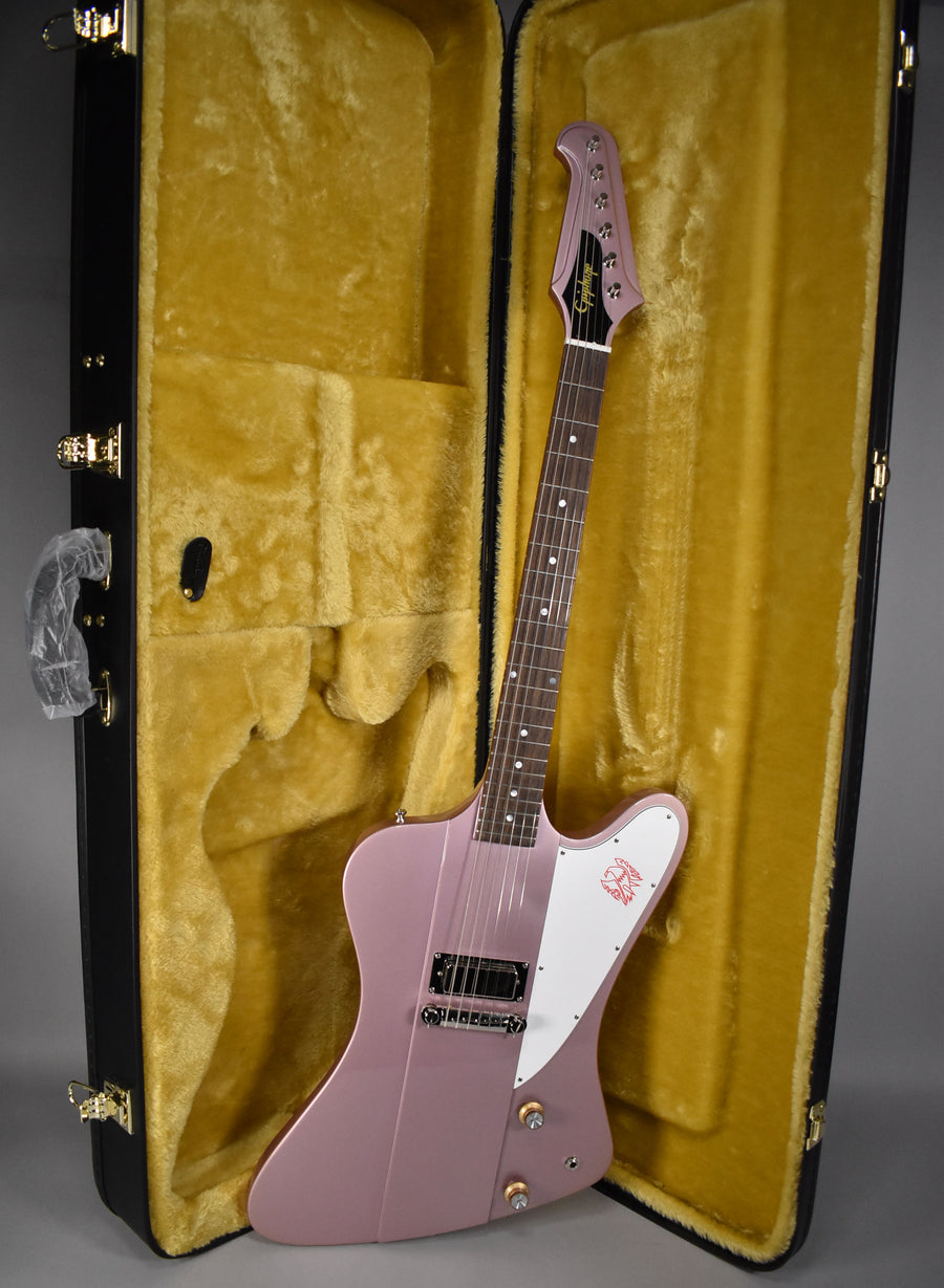 Full view of a metallic heather poly Firebird I electric guitar with a white pickguard, resting in its open, gold-lined hard case.