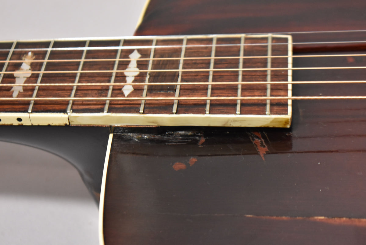Close-up of the sunburst body and lower fretboard, showing wear, checking, and finish loss around the neck joint.