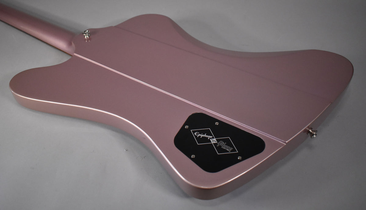 The back of a heather poly Firebird guitar, showing the neck joint, strap buttons, and control cavity cover.