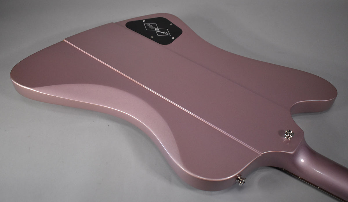 The back of a metallic heather poly Firebird guitar, showing the neck joint, strap buttons, and a black control cavity cover.