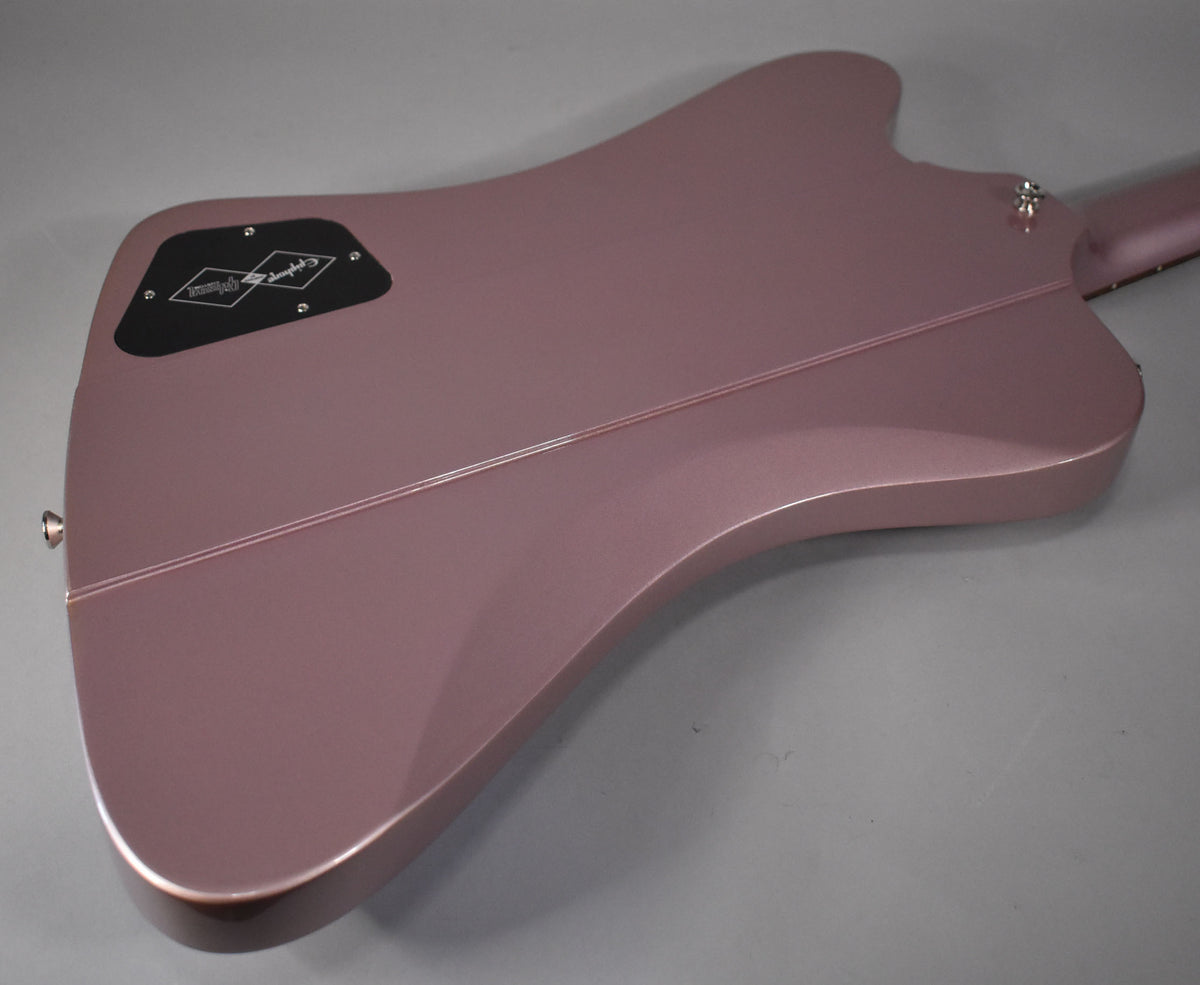 The back of a heather poly Firebird guitar, showing the control cavity cover and neck joint.