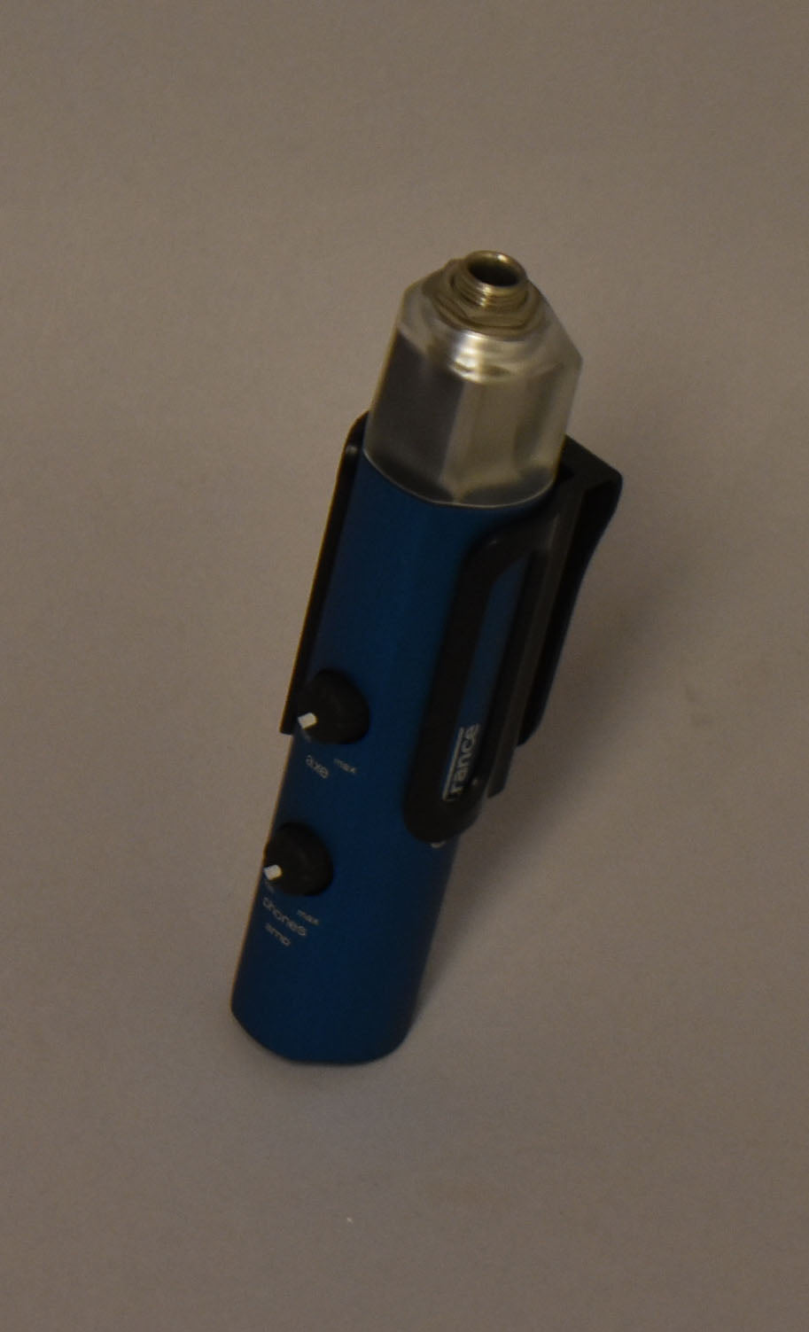 A blue cylindrical recording interface with a silver hexagonal top, two black control knobs, and a black plastic belt clip.