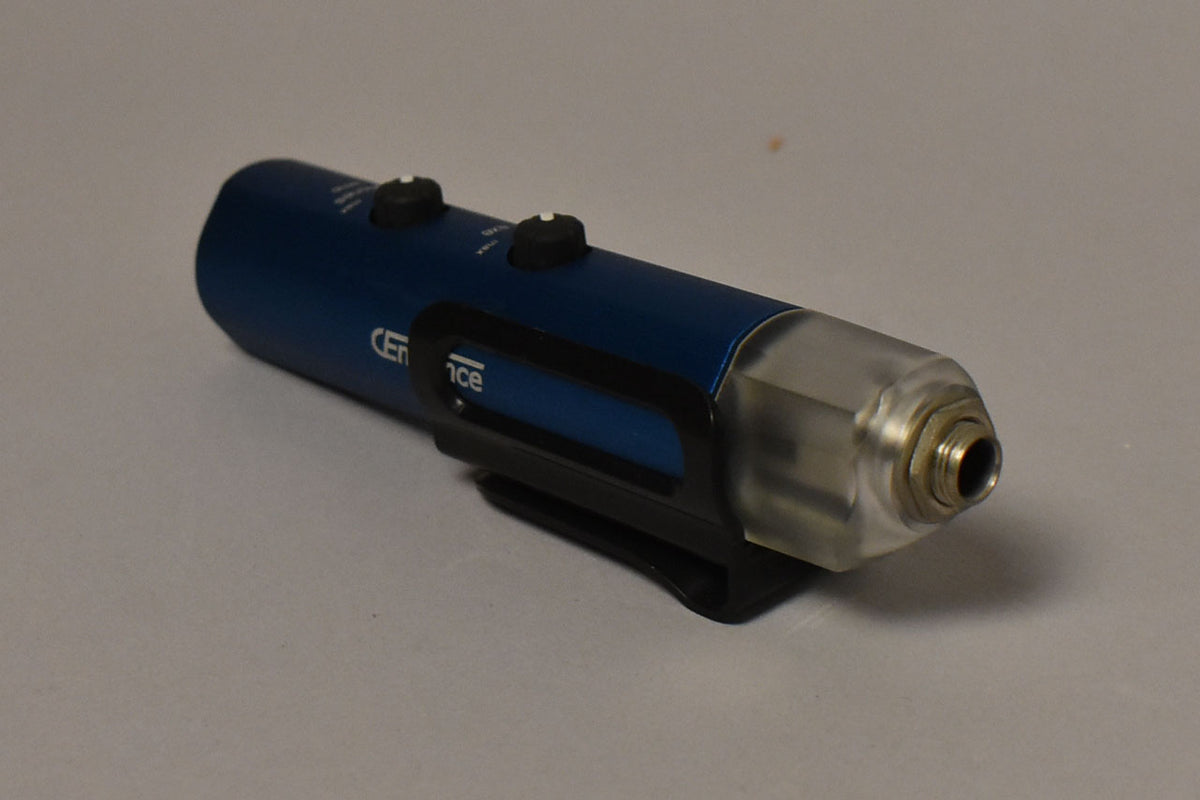 A blue cylindrical recording interface with two black control knobs, a black belt clip, and a clear plastic end cap with a metal jack.