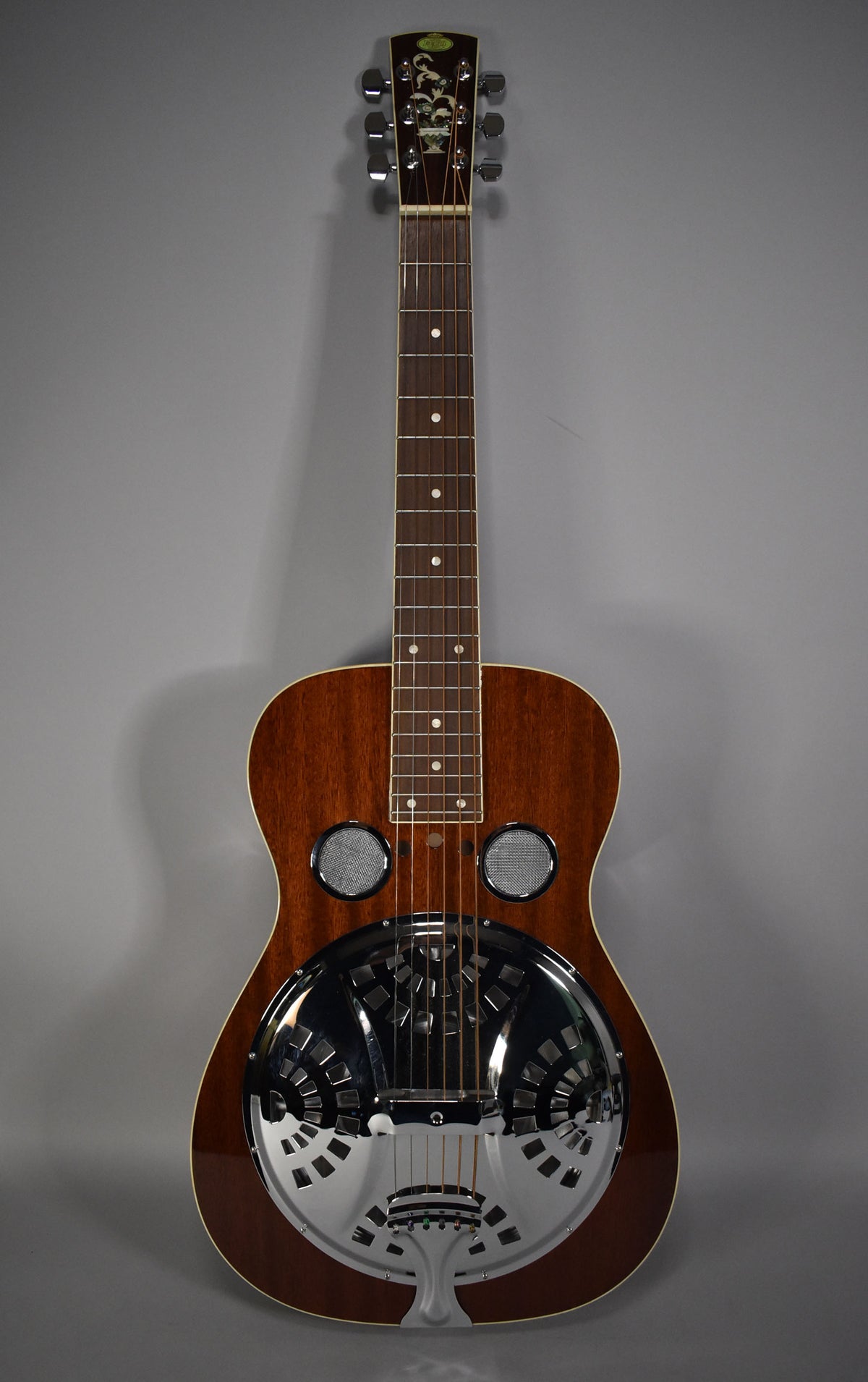 Full front view of a dark brown resonator guitar with a chrome-plated resonator cone and two round sound screens.