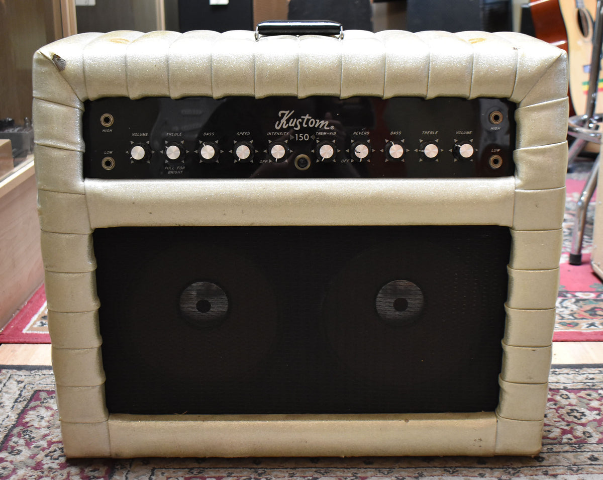 Front view of a vintage combo amp with a sparkly off-white tuck-and-roll finish, black control panel, and two visible speakers.