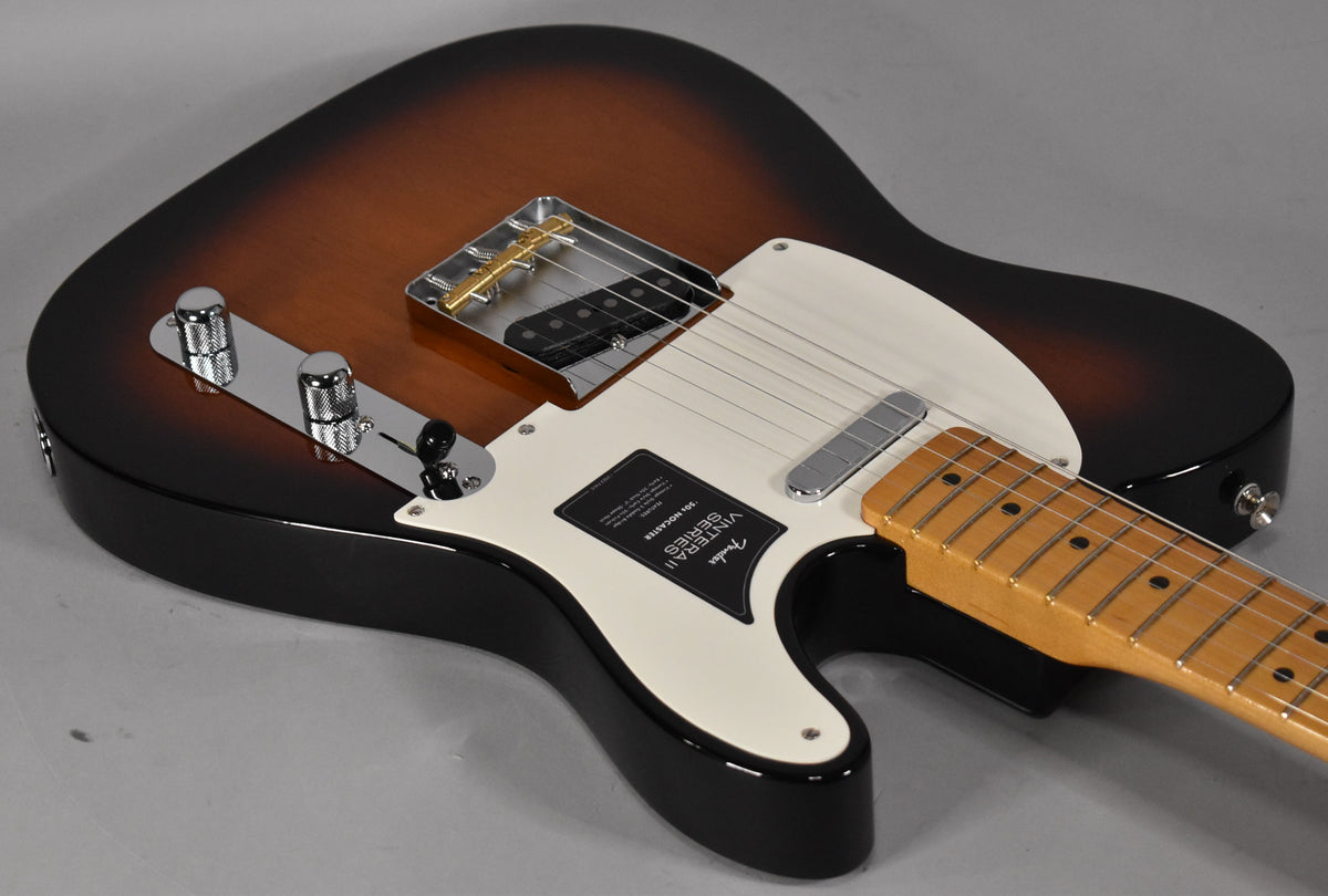 The Nocaster's body, with a 2-color sunburst finish, is angled from the lower right, showing its cream pickguard and chrome hardware.