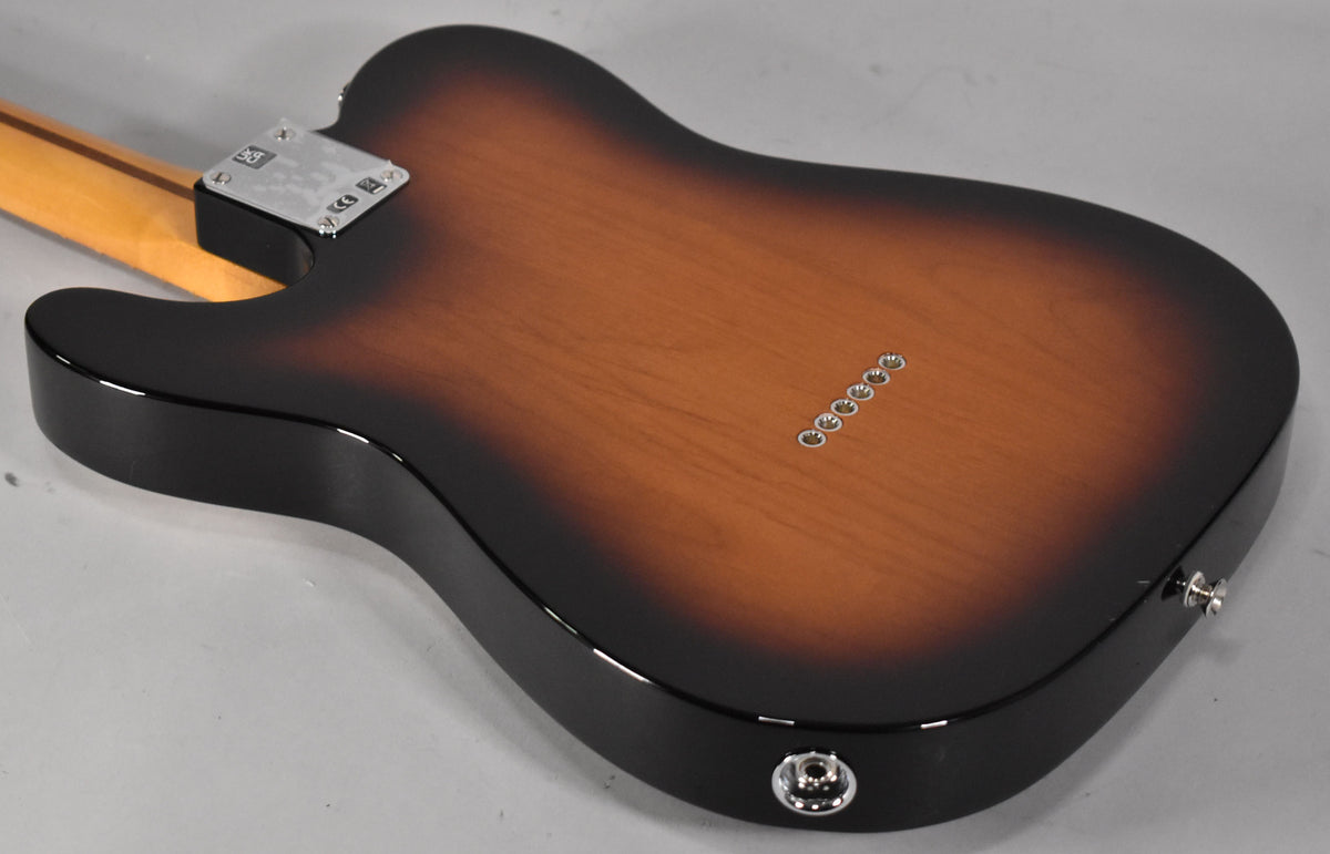 The guitar's back, in a glossy 2-color sunburst, shows six string ferrules, a chrome neck plate, and a jack socket.