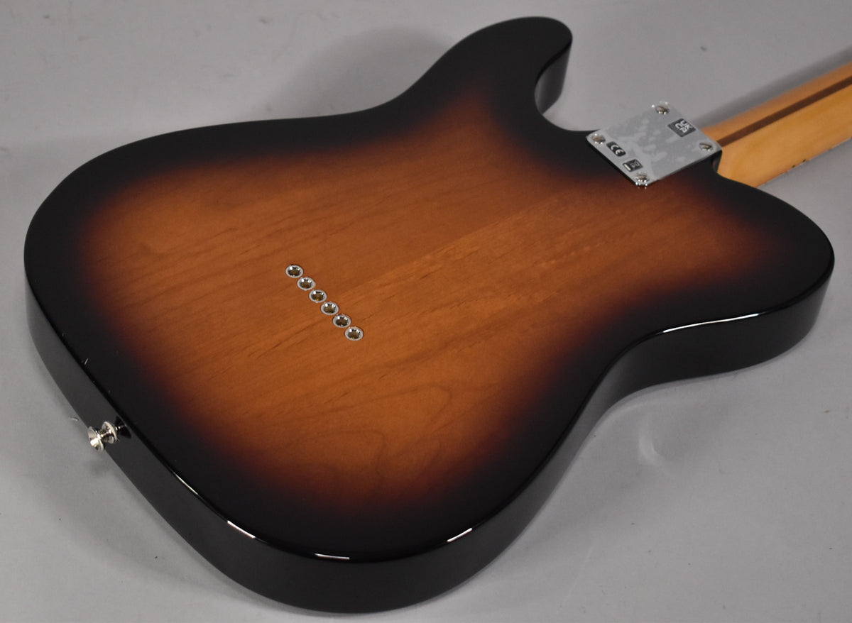The back of the guitar shows a glossy 2-color sunburst finish, six string-through-body ferrules, and a chrome neck plate.