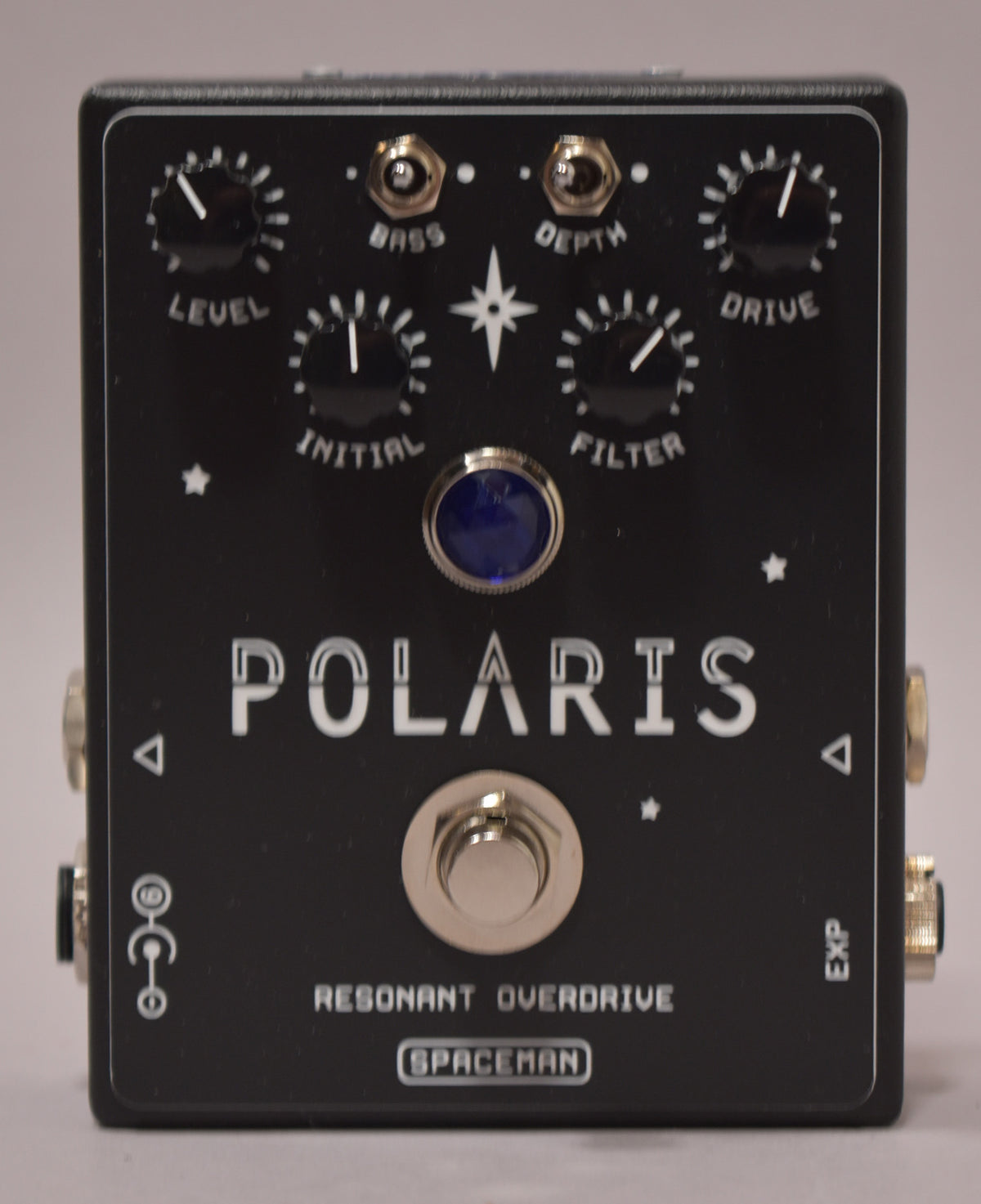 A black guitar pedal with a blue LED and silver footswitch, five black knobs, and two mini-toggle switches.