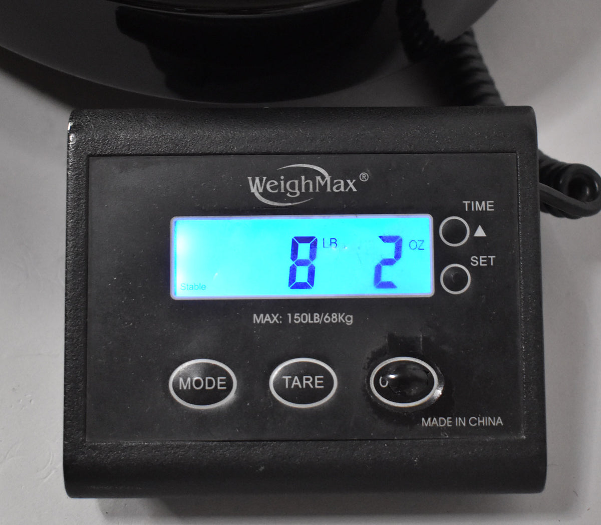 A black digital scale displays "8 LB 2 OZ" in bright blue text, with "Stable" lit below the numbers.