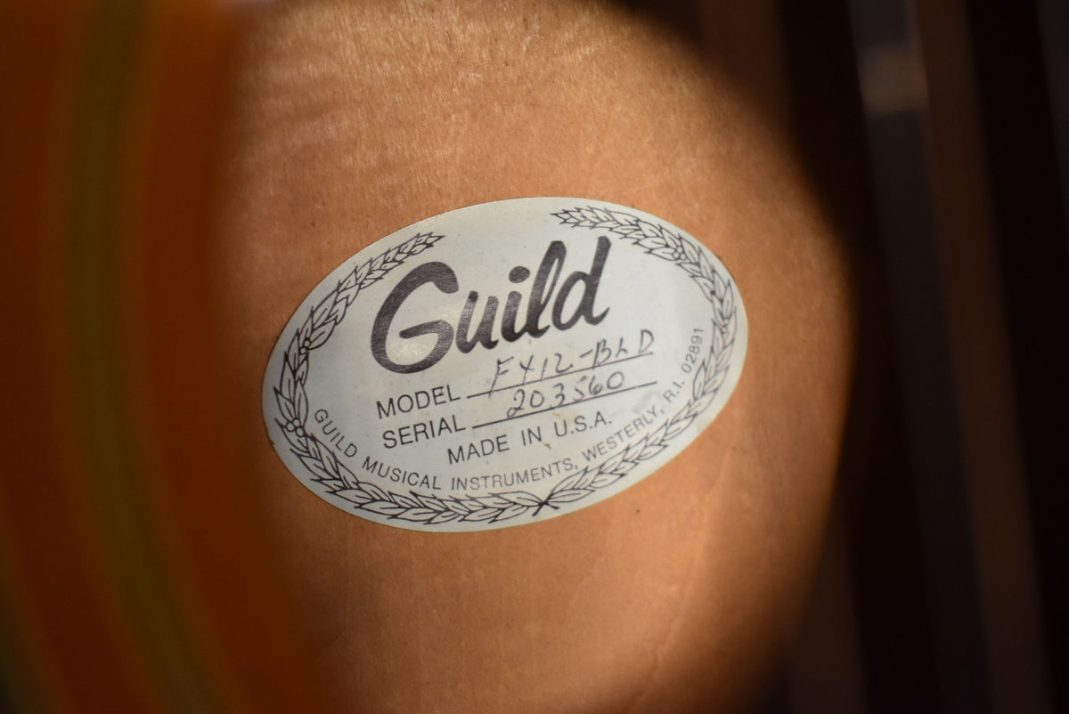 A close-up of the guitar's interior label, showing "Guild" in script, "MODEL F412-BLD", "SERIAL 203560", and "MADE IN U.S.A.".