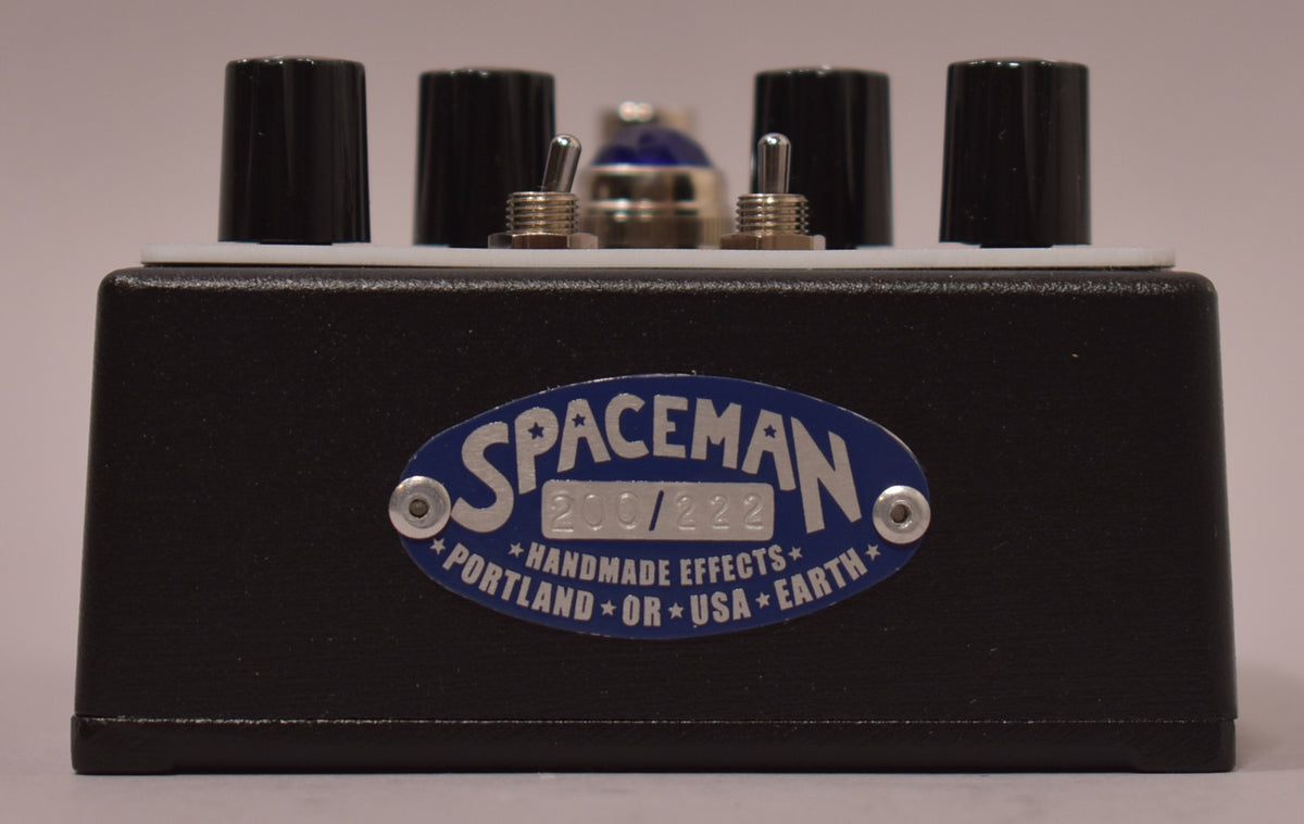 A black guitar pedal with four black knobs and two silver toggle switches on top, and a blue "SPACEMAN 200/222" label.