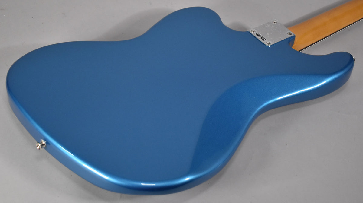 The back of a Lake Placid Blue bass guitar, showing a metallic finish, a chrome neck plate, and a strap button.
