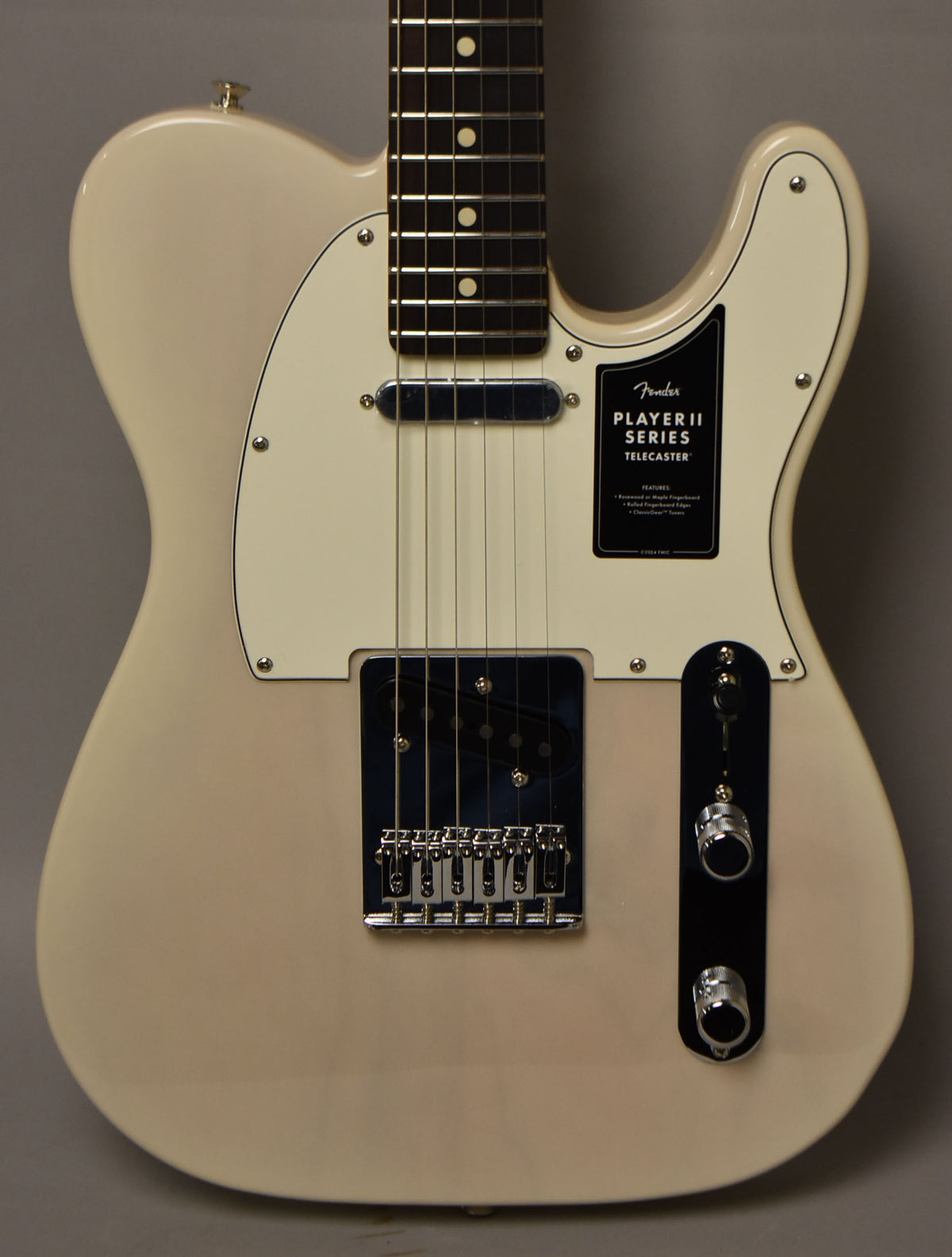 A white blonde Telecaster body, with a white pickguard, chrome hardware, and a black control plate with two knobs.