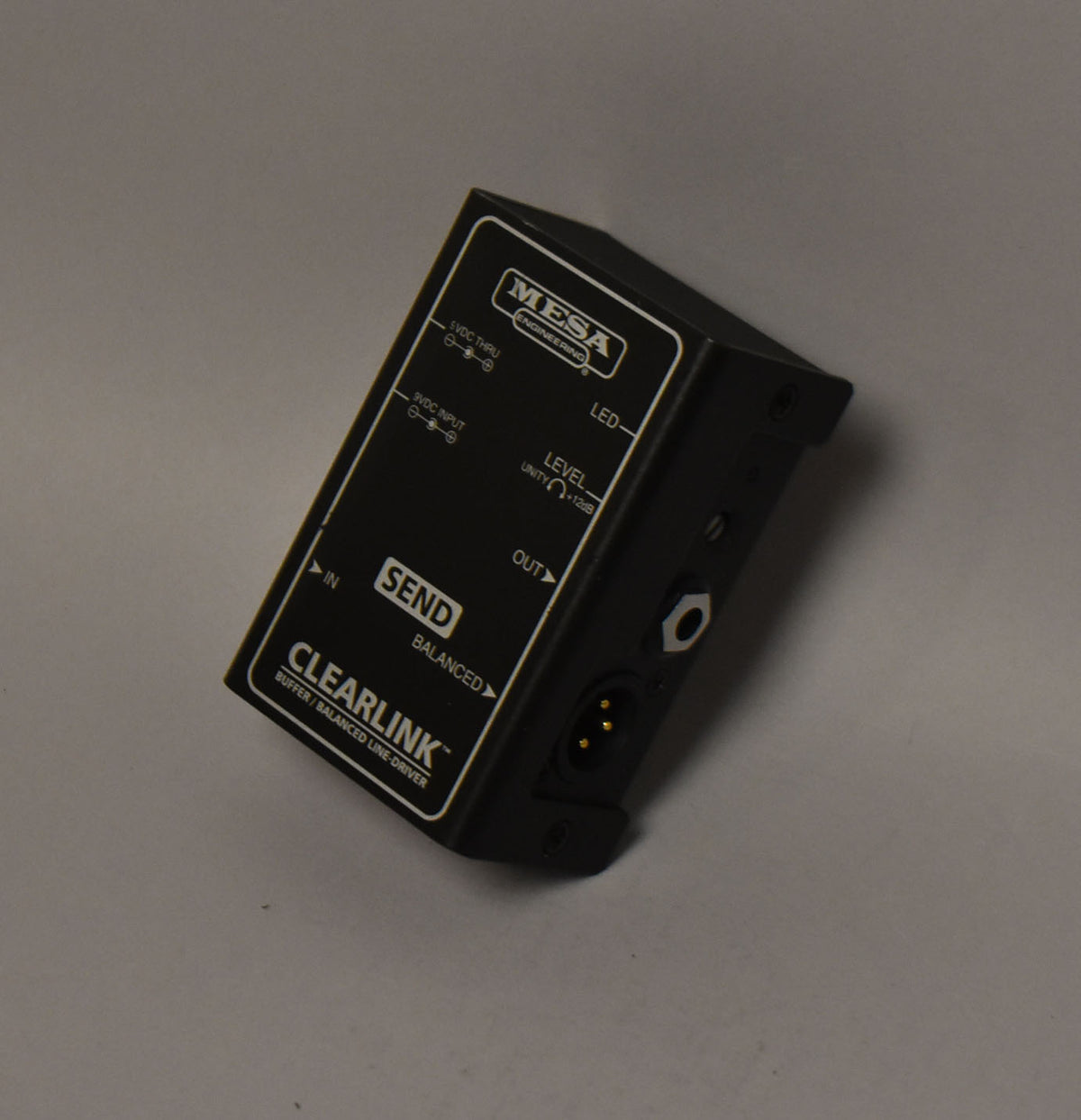 Black rectangular pedal, angled from above, showing the top panel with white text and the right side with a 1/4-inch jack and XLR output.