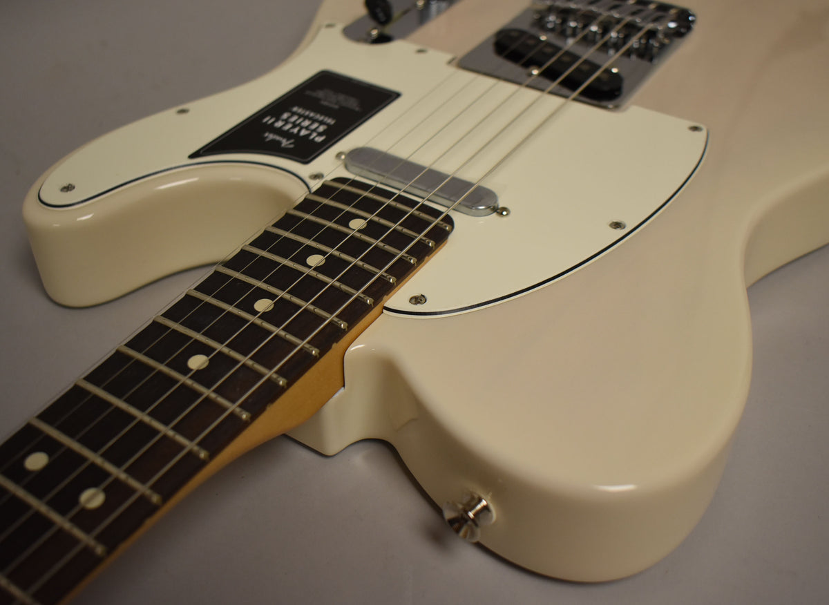 Close-up of a white blonde Telecaster body and neck, showing the cream pickguard, chrome bridge, and neck pickup.
