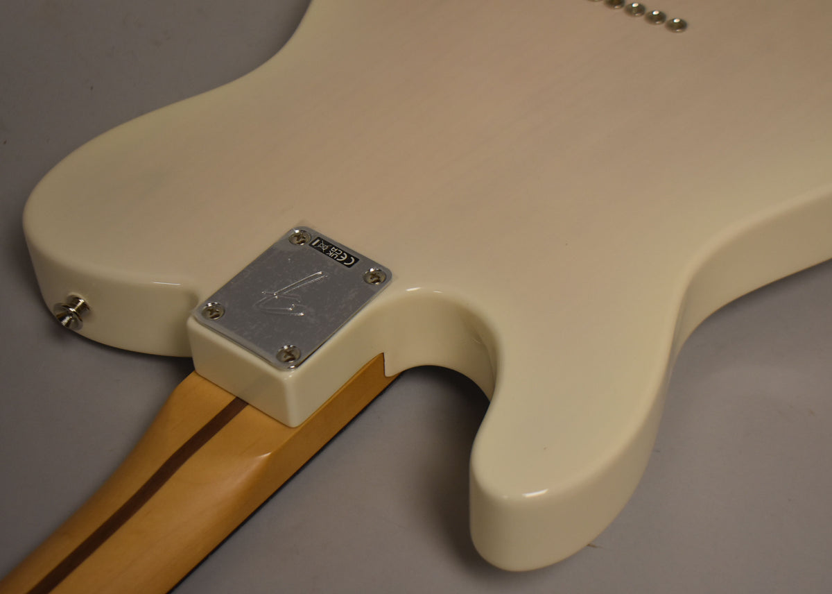 Rear view of the Telecaster's white blonde body, showing the neck plate, strap button, and six string ferrules on the upper bout.