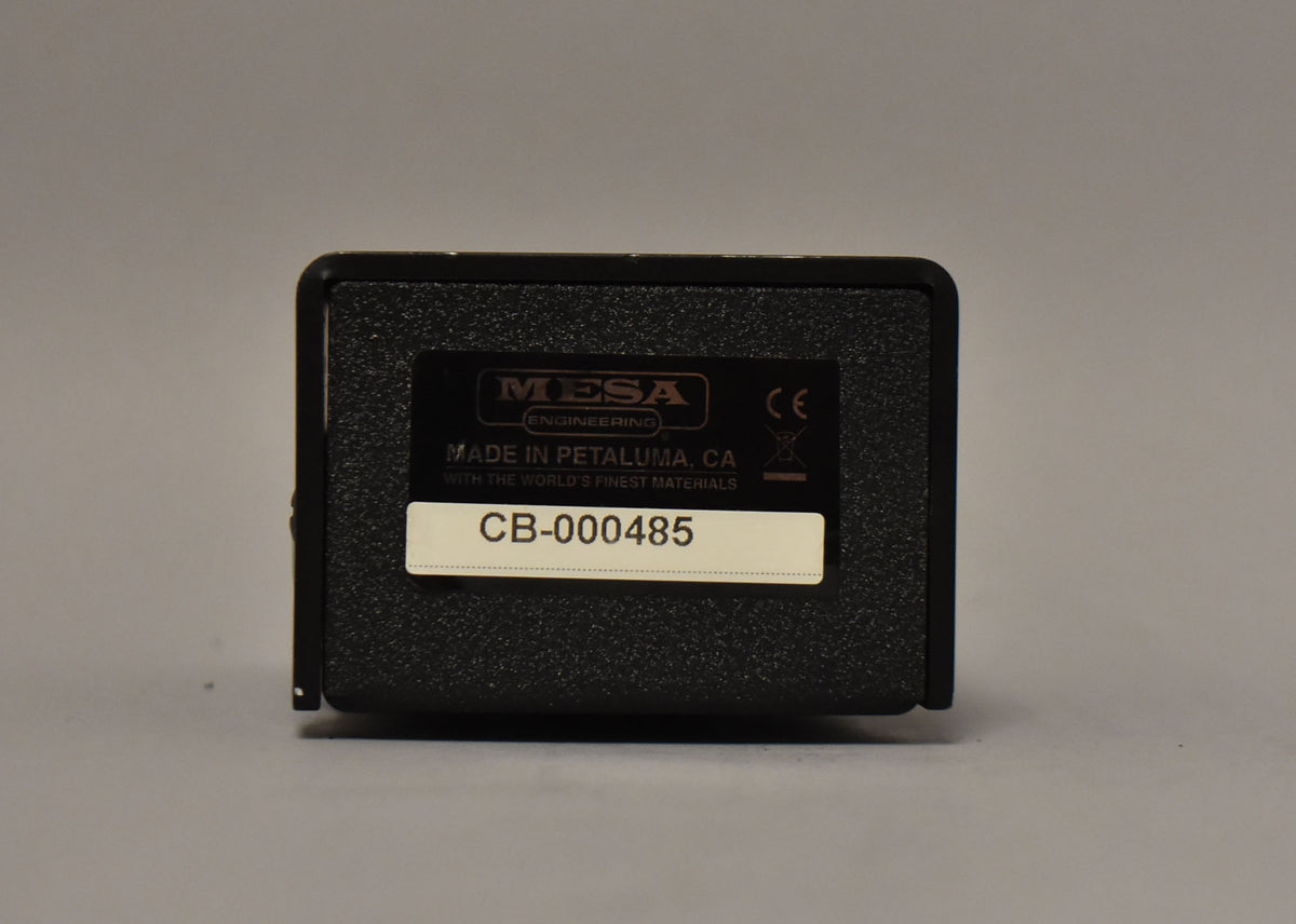 The black textured pedal is viewed from the back, showing a rectangular label with "CB-000485" on a light-colored strip.
