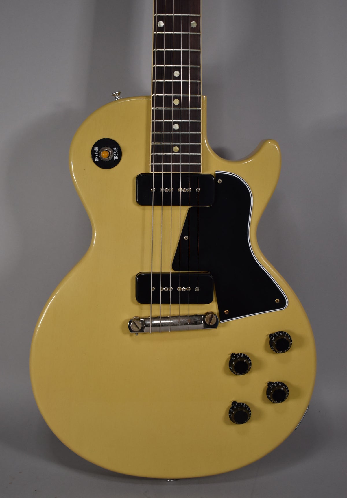 The full TV Yellow single-cut guitar is shown from the front, featuring two black P90 pickups, a black pickguard, and four black control knobs.