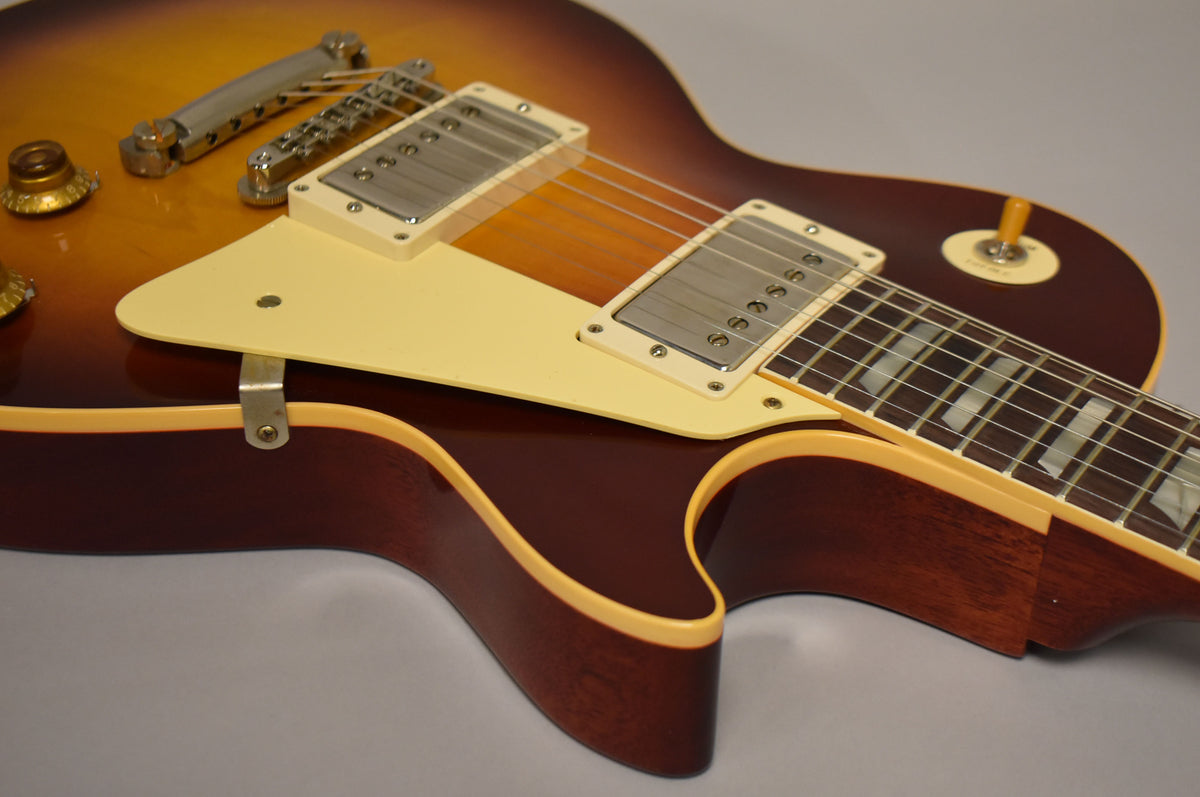 Close-up of the Bourbon Burst body, showing the cream pickguard, two humbuckers, bridge, tailpiece, and part of the fretboard.