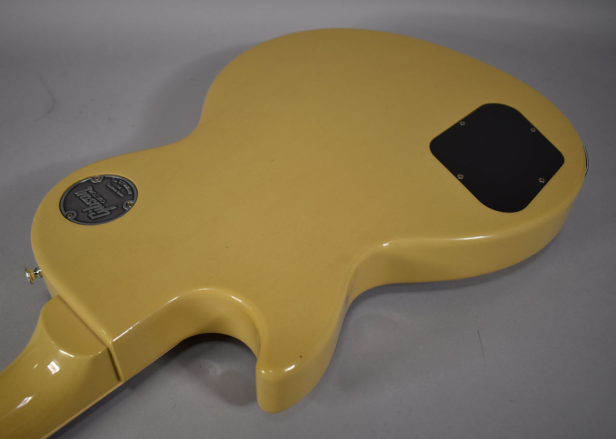 The TV yellow guitar body is shown from the back, angled from the neck joint to the lower bout, revealing a black control cavity cover.
