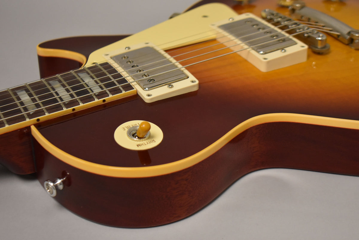 Close-up of the guitar's lower bout, showing the Bourbon Burst finish, cream binding, pickup selector, and nickel hardware.