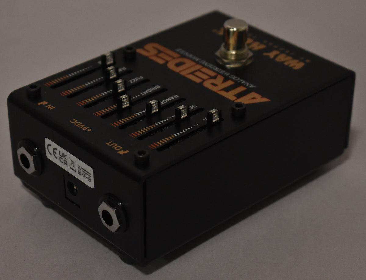 Black pedal with orange lettering, six silver slider controls, and a gold footswitch, viewed from the front-right.