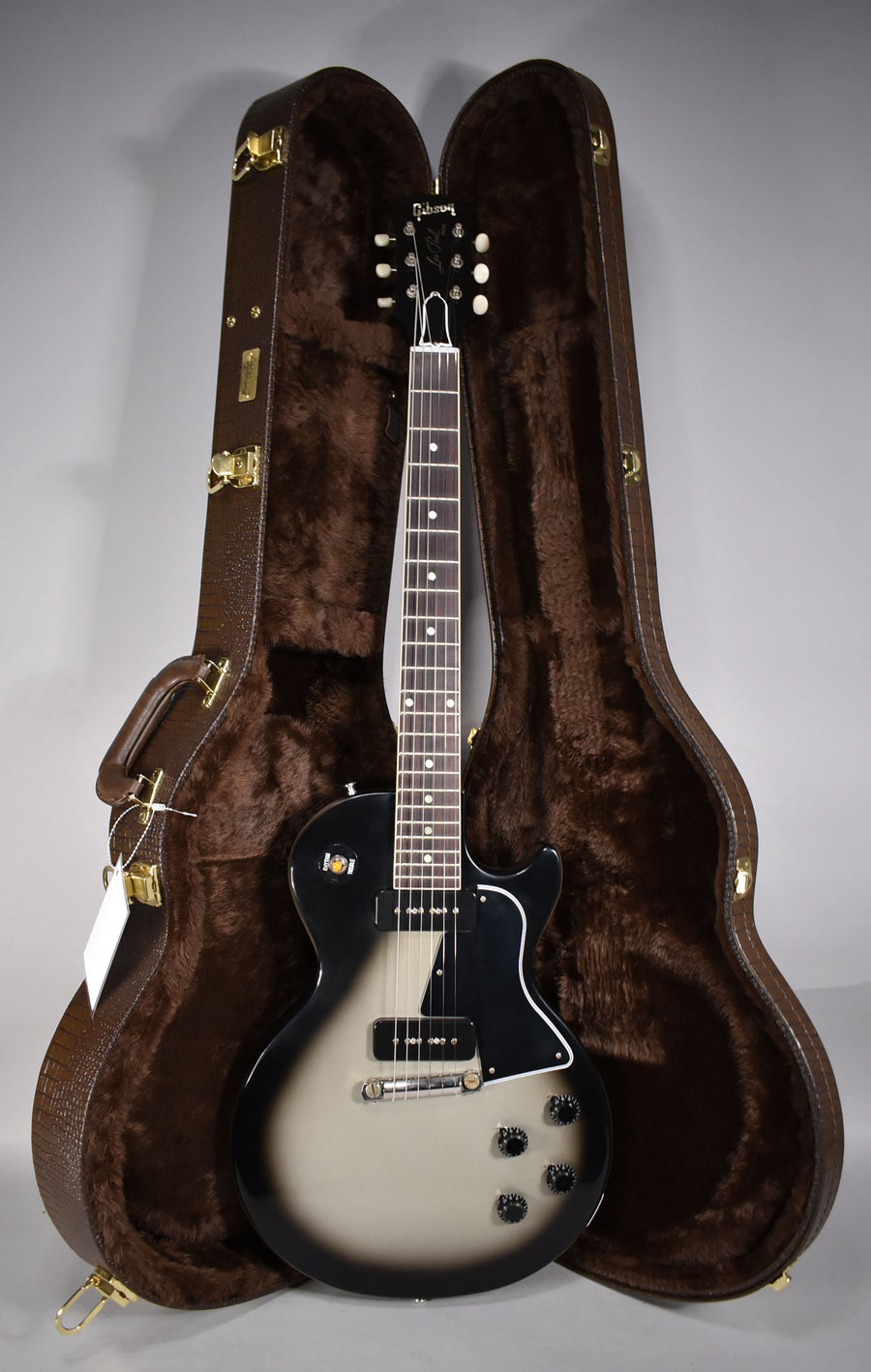 Full-length view of a Les Paul Special in Antique Silverburst, with two P90 pickups and a brown faux-alligator hard case.