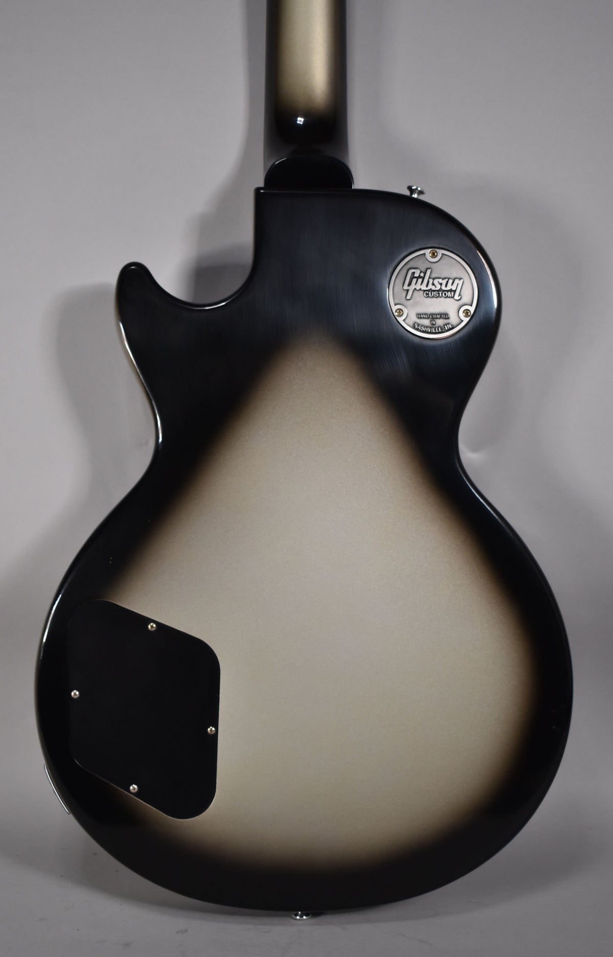 Full back view of the Les Paul Special, showing its Antique Silverburst finish with a black control cavity cover and a chrome Custom Shop medallion.