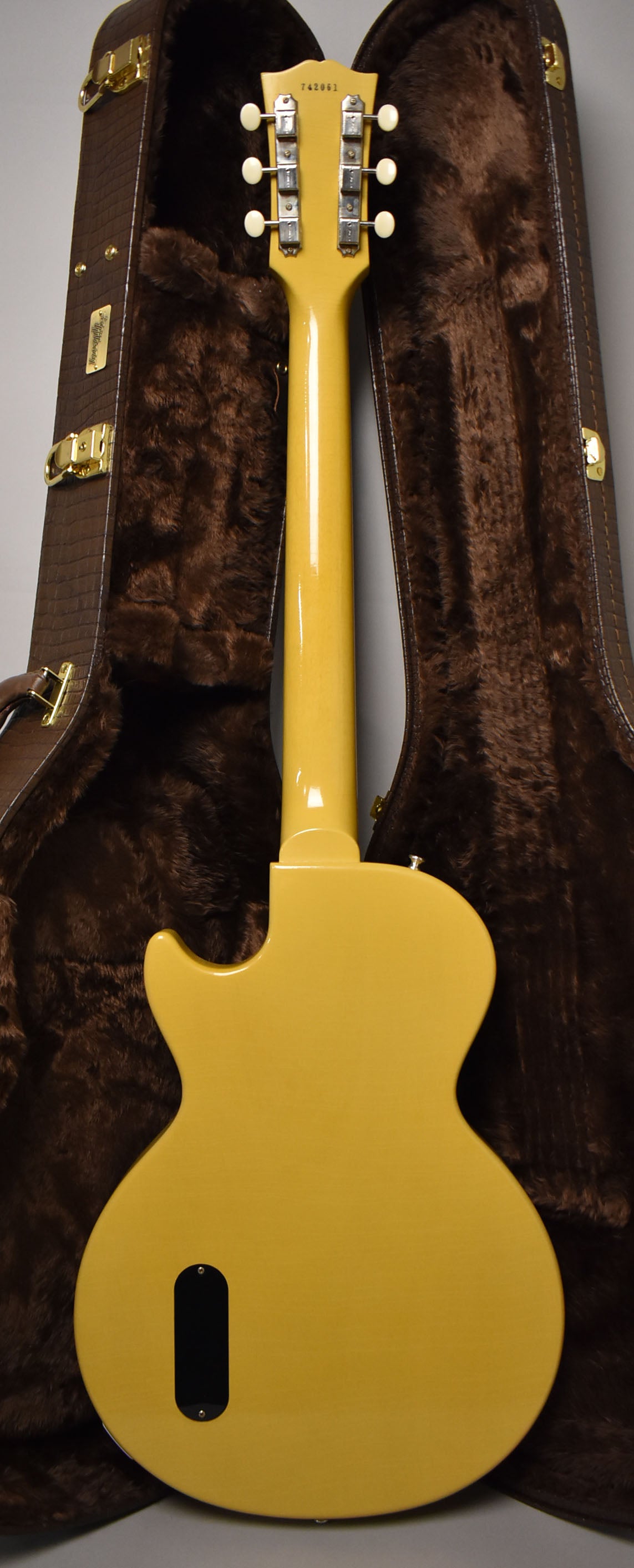 The back of a TV Yellow guitar, showing the headstock with six white tuners, neck, and body with a black control plate.