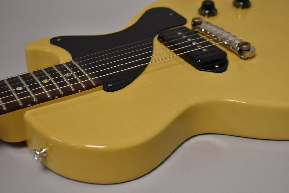 The TV Yellow body, with a black pickguard and single P90 pickup, shows subtle finish checking and light wear.