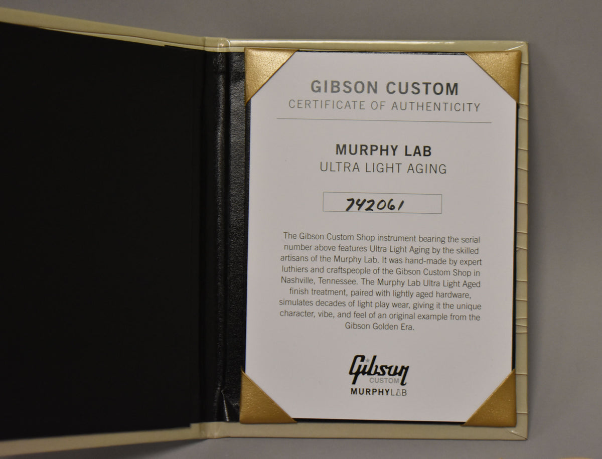 An open black folder with a white Certificate of Authenticity, held by gold corner tabs, showing "MURPHY LAB ULTRA LIGHT AGING" and serial number "742061".