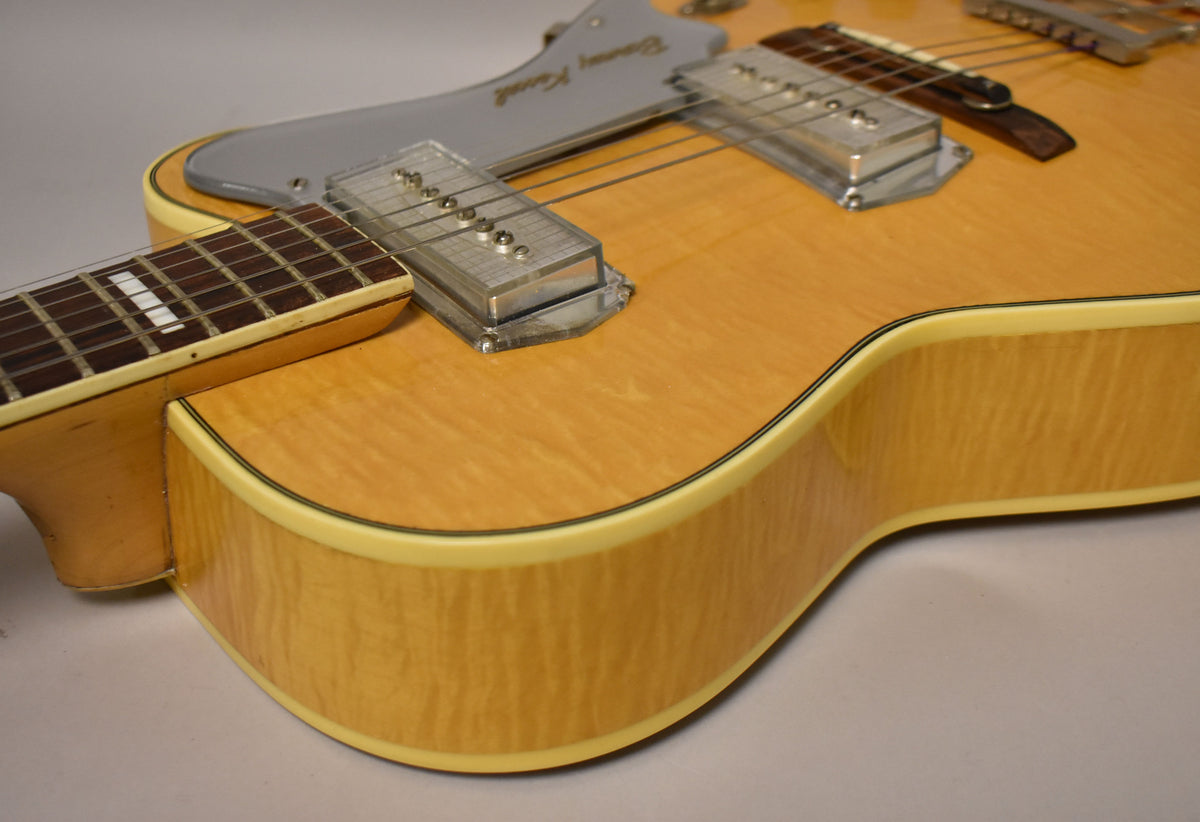 Close-up of the natural finish, flamed maple body and neck heel, showing the neck pickup, pickguard, and binding.