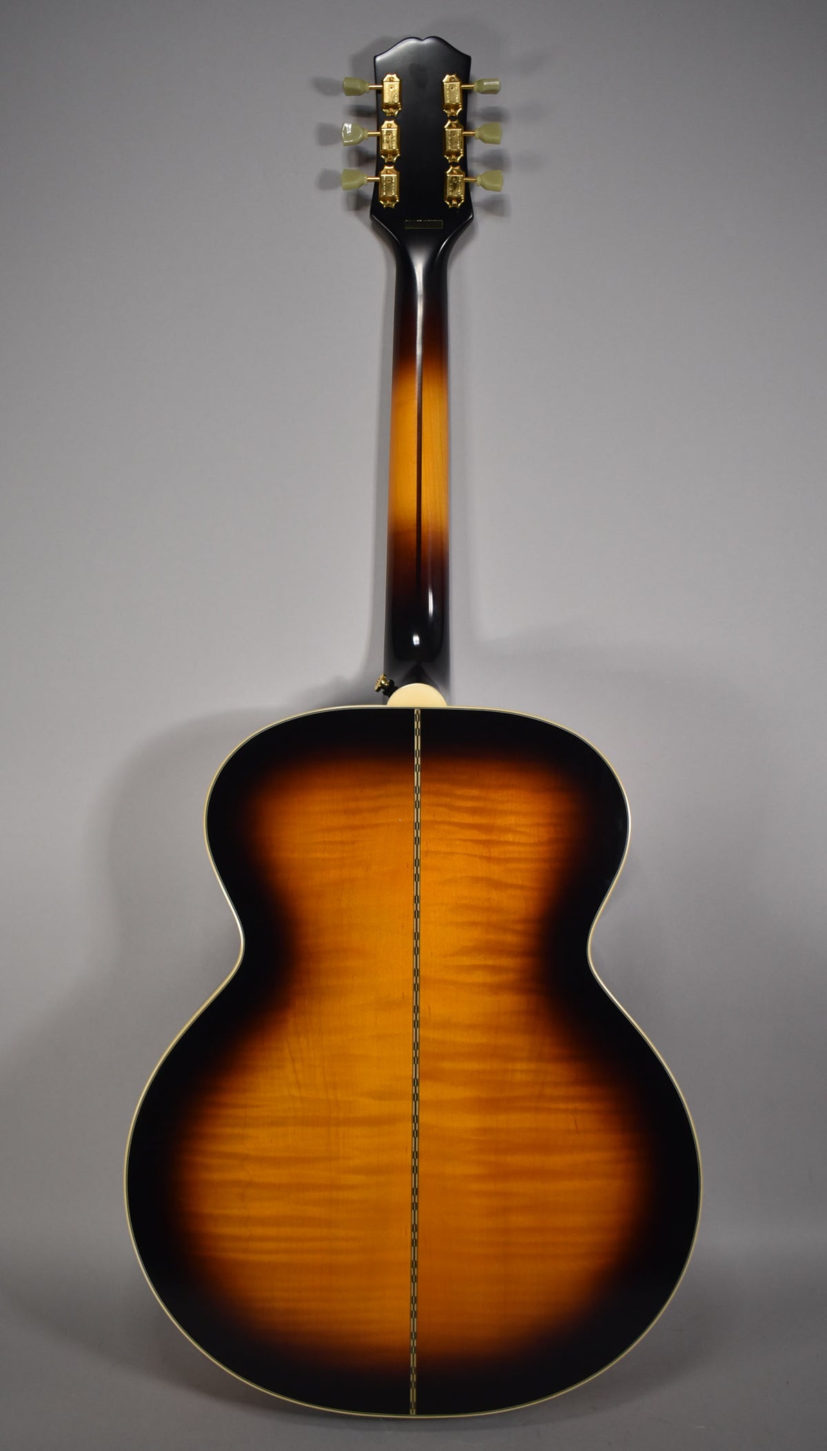 Full back view of the guitar, showing a glossy aged vintage sunburst finish with flame maple grain and a double-line back strip.