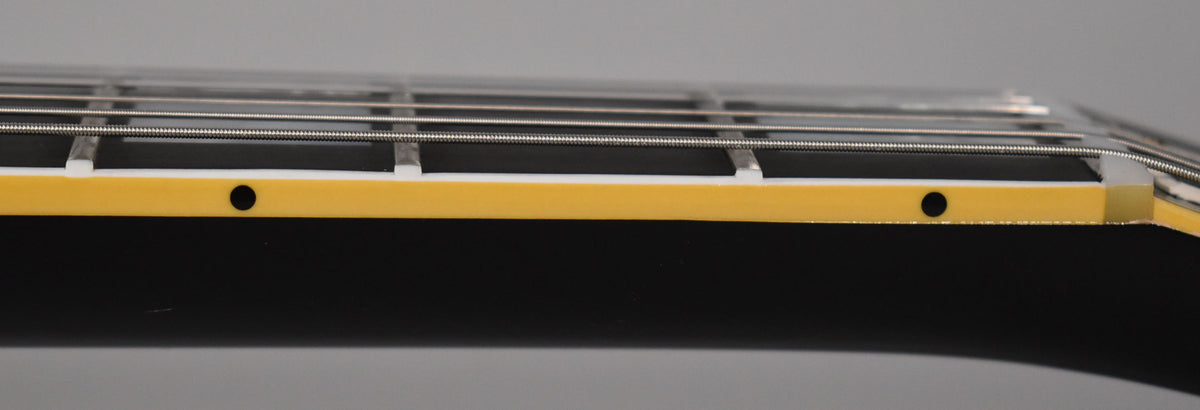 Close-up of the guitar's ebony fretboard and binding, showing two black side dot markers on the aged cream binding.