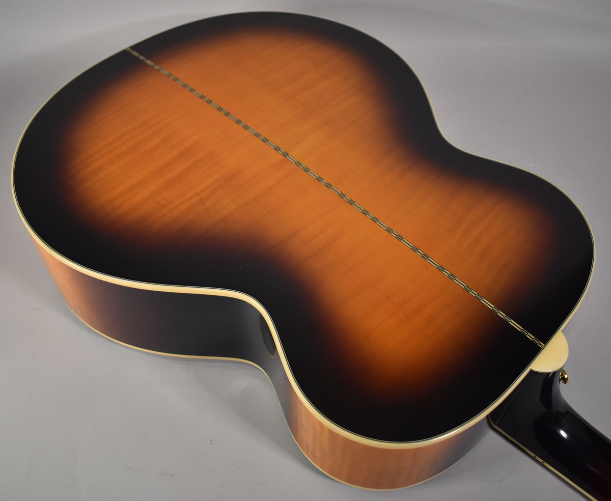 The guitar's back and sides are shown, featuring a glossy vintage sunburst finish with a visible center seam and cream binding.